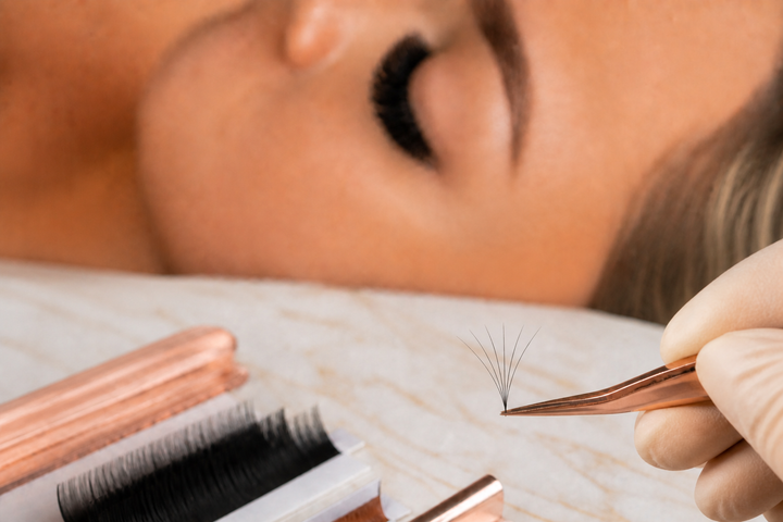 Lash artist comparing an Easy Fan pickup with a traditional handmade volume fan